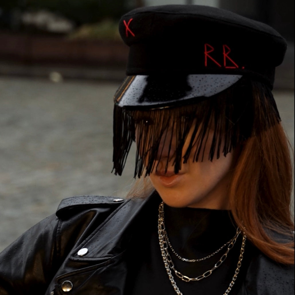 Ruslan Baginskiy hat in classic style, inspired by Emily in Paris fashion.